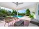 Outdoor patio with wicker seating overlooking a sparkling swimming pool and landscaped backyard at 1301 Fahnstock St, Eustis, FL 32726