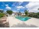 Backyard with a sparkling pool, surrounded by lush landscaping and a sunny sky at 1301 Fahnstock St, Eustis, FL 32726