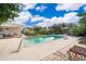 Swimming pool is in the backyard with lush greenery and clear blue skies at 1301 Fahnstock St, Eustis, FL 32726