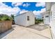 Exterior view of a white shed with a door, set in a well-maintained backyard at 1301 Fahnstock St, Eustis, FL 32726