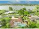 Aerial view of the home within its neighborhood showcasing its pool and landscaping by the lake at 137 N Spring Lake Dr, Altamonte Springs, FL 32714