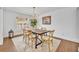 Stylish dining room with rustic wooden table and contemporary chandelier, perfect for gatherings at 137 N Spring Lake Dr, Altamonte Springs, FL 32714