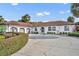 Elegant single-story home with an expansive driveway, attached garage, and beautifully maintained landscaping at 137 N Spring Lake Dr, Altamonte Springs, FL 32714
