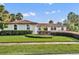 Beautiful single-story home with lush landscaping and a well-manicured lawn under a bright, sunny sky at 137 N Spring Lake Dr, Altamonte Springs, FL 32714