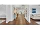 Inviting hallway showcasing hardwood floors, white walls, and modern decor leading to open living spaces at 137 N Spring Lake Dr, Altamonte Springs, FL 32714