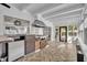 A sunroom kitchen featuring brick and metal cabinet, light tile floors, stainless steel hood and access to the pool at 137 N Spring Lake Dr, Altamonte Springs, FL 32714