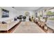 Open living area with elegant piano, plush seating, and an area rug; brightened by large windows at 137 N Spring Lake Dr, Altamonte Springs, FL 32714