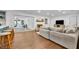 Bright living room with wood floors, shiplap walls, fireplace, and access to a screened-in porch at 137 N Spring Lake Dr, Altamonte Springs, FL 32714