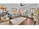 Living room with wood floors, neutral sofa, plants, and dining area with a view of the outdoors at 137 N Spring Lake Dr, Altamonte Springs, FL 32714