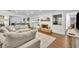 Open concept living room with wood floors, fireplace, and access to the kitchen and screened-in patio at 137 N Spring Lake Dr, Altamonte Springs, FL 32714