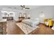 Bright main bedroom featuring wood floors, ceiling fan, and en suite bath with dual sinks at 137 N Spring Lake Dr, Altamonte Springs, FL 32714