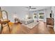 Bright main bedroom featuring wood floors, ceiling fan, and sliding glass doors leading to a pool at 137 N Spring Lake Dr, Altamonte Springs, FL 32714