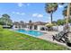 Backyard pool with a lounge area, outdoor dining, grill, and tropical landscaping at 137 N Spring Lake Dr, Altamonte Springs, FL 32714
