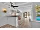 Entertainer's sunroom featuring a bar with tiled flooring, white walls and ceiling, and access to the outdoor pool area at 137 N Spring Lake Dr, Altamonte Springs, FL 32714