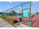 Community tennis court featuring well-maintained red courts, green fencing, and tidy landscaping at 137 N Spring Lake Dr, Altamonte Springs, FL 32714