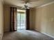 Well-lit carpeted bedroom featuring a ceiling fan and sliding glass doors to the outside at 1370 Tuscan Ter # 2202, Davenport, FL 33896