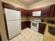 Kitchen with stainless steel appliances, granite counters, and wood cabinets at 1370 Tuscan Ter # 2202, Davenport, FL 33896