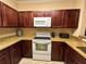 Spacious kitchen with granite counters, stainless steel appliances, and wood cabinets at 1370 Tuscan Ter # 2202, Davenport, FL 33896