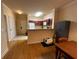 An open concept kitchen with a breakfast bar and a living room featuring hardwood floors at 1370 Tuscan Ter # 2202, Davenport, FL 33896