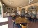 Inviting outdoor bar area features seating, ceiling fans, and doors to the outdoors at 1370 Tuscan Ter # 2202, Davenport, FL 33896