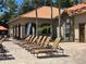 Community pool deck with plenty of sun loungers and palm trees at 1370 Tuscan Ter # 2202, Davenport, FL 33896