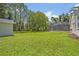 Large backyard with well-maintained lawn, mature trees, and a pool enclosure at 14128 Bramble Bush Ct, Orlando, FL 32832