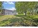 Spacious backyard featuring a pool with a screened enclosure and a storage shed at 14128 Bramble Bush Ct, Orlando, FL 32832