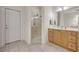 This bathroom features a glass shower, tile floors, and a wood vanity with a large mirror at 14128 Bramble Bush Ct, Orlando, FL 32832