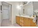 Bathroom featuring double vanity and wood cabinets at 14128 Bramble Bush Ct, Orlando, FL 32832
