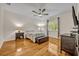 Bedroom with hardwood flooring, ceiling fan, and natural light at 14128 Bramble Bush Ct, Orlando, FL 32832