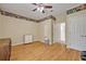 A bright room with wood floors, colorful border, and a door leading to another room at 14128 Bramble Bush Ct, Orlando, FL 32832