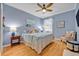 Comfortable bedroom featuring wood floors, a ceiling fan, and a large bed with decorative pillows at 14128 Bramble Bush Ct, Orlando, FL 32832