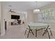 Open-concept dining room with chandelier and an adjacent bonus room at 14128 Bramble Bush Ct, Orlando, FL 32832