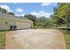 Wide driveway leading to a two-car garage, lush trees in the background at 14128 Bramble Bush Ct, Orlando, FL 32832