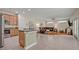 Open concept kitchen with granite countertops and stainless steel appliances that flows into the living room at 14128 Bramble Bush Ct, Orlando, FL 32832
