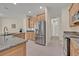 Well-lit kitchen featuring stainless steel appliances and granite countertops, leading into a hallway at 14128 Bramble Bush Ct, Orlando, FL 32832