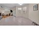 Open living space with tile floors, neutral paint, and an adjacent dining area at 14128 Bramble Bush Ct, Orlando, FL 32832