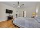 Spacious main bedroom featuring hardwood floors, ceiling fan, and natural light at 14128 Bramble Bush Ct, Orlando, FL 32832
