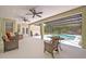 Screened lanai with ceiling fans and outdoor seating overlooking the pool at 14128 Bramble Bush Ct, Orlando, FL 32832