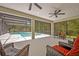 The spacious screened patio overlooks a pool and the natural beauty of the property at 14128 Bramble Bush Ct, Orlando, FL 32832