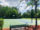 Community basketball courts featuring multiple hoops and a shaded bench under a bright blue sky at 14700 Chadbury Ct, Orlando, FL 32828