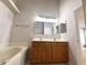 Bathroom featuring double vanity and soaking tub at 14700 Chadbury Ct, Orlando, FL 32828