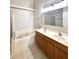 Bathroom featuring double vanity and soaking tub at 14700 Chadbury Ct, Orlando, FL 32828