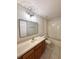 Well-lit bathroom with a single sink vanity, mirror, and a combined tub and shower at 14700 Chadbury Ct, Orlando, FL 32828