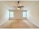 Neutral bedroom featuring two windows and ceiling fan at 14700 Chadbury Ct, Orlando, FL 32828