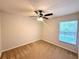 Bedroom features carpet, ceiling fan, and a window providing natural light and neighborhood views at 14700 Chadbury Ct, Orlando, FL 32828