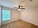 Bedroom with plush carpet, ceiling fan, and a large window offering natural light and views at 14700 Chadbury Ct, Orlando, FL 32828