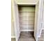 Open white closet with multiple shelves providing ample storage space at 14700 Chadbury Ct, Orlando, FL 32828