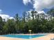 Large community pool with plenty of lounge chairs and umbrellas at 14700 Chadbury Ct, Orlando, FL 32828