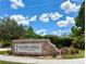 Stone entrance sign for Stoneybrook recreation complex with lush landscaping under a bright blue sky at 14700 Chadbury Ct, Orlando, FL 32828